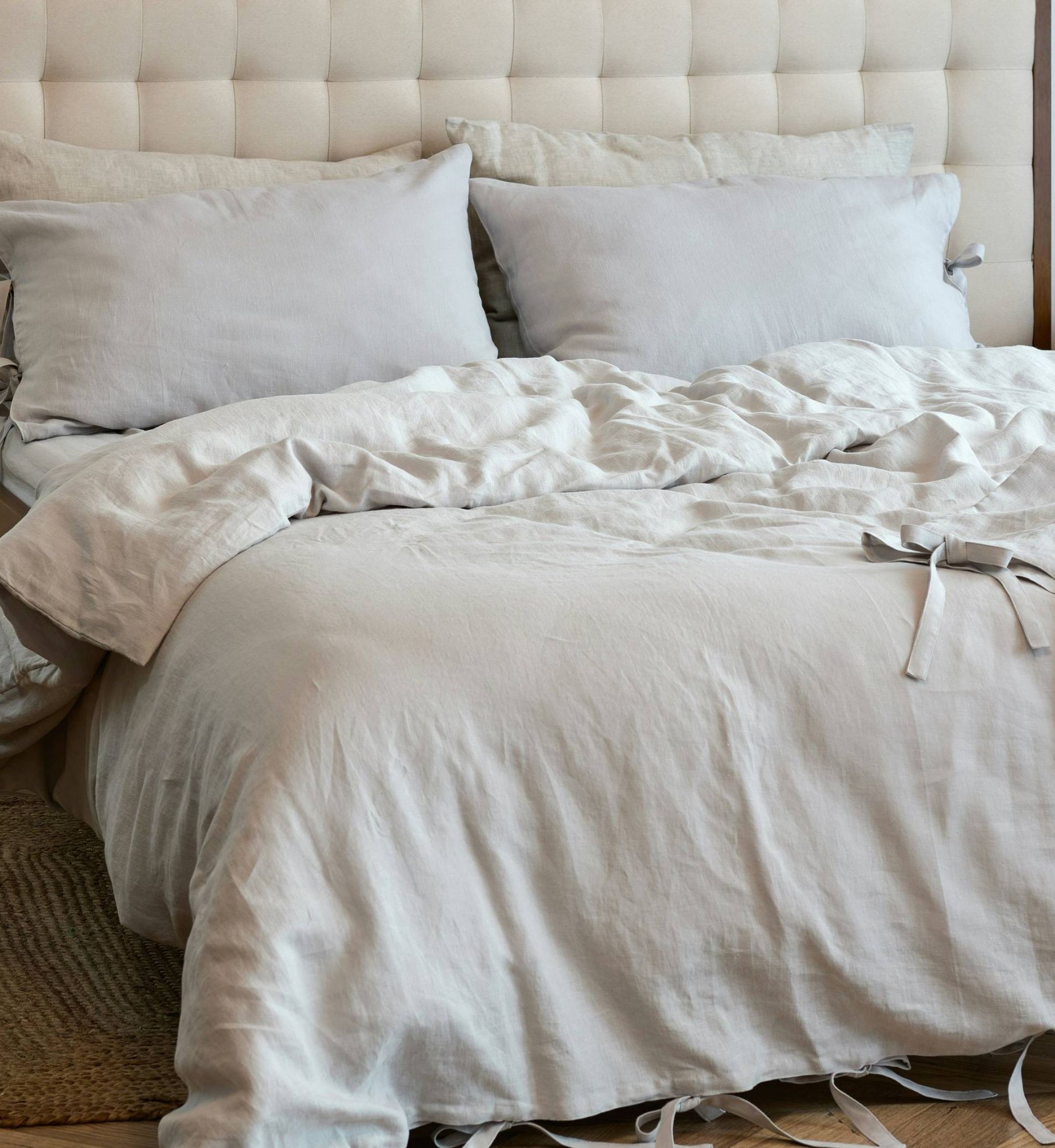 The Sloan at LoSo apartments in Charlotte, NC - bed with beige comforter and pillows